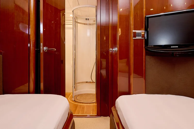  Yacht Photos Pics Luxurious cabin interior of 2009 Princess 23M yacht with twin beds and TV.