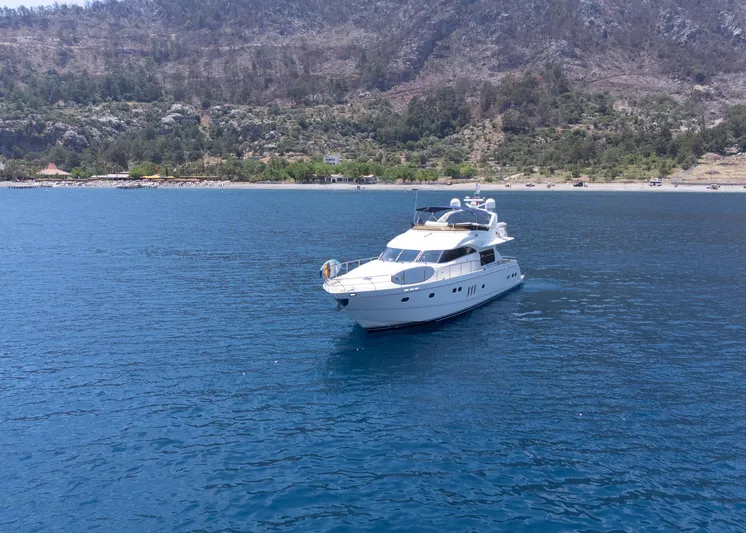  Yacht Photos Pics Luxury yacht Princess 23M (2009) cruising on serene blue waters near a scenic coastline.