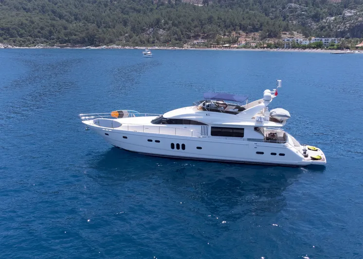  Yacht Photos Pics Luxurious 2009 Princess 23M yacht cruising on serene blue waters near a forested coastline.