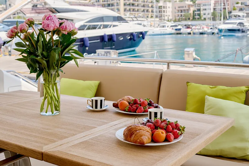  Yacht Photos Pics Luxurious yacht deck with breakfast setup, flowers, and marina view. Princess 23M, 2009 model.