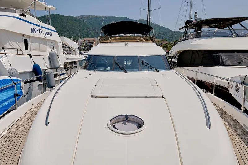  Yacht Photos Pics 2009 Princess 23M yacht docked between other boats in a marina.