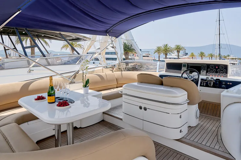  Yacht Photos Pics Luxurious 2009 Princess 23M yacht interior with elegant seating, table, and scenic marina view.