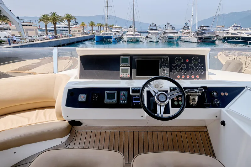  Yacht Photos Pics Helm of 2009 Princess 23M yacht with marina view, featuring modern controls and navigation equipment.