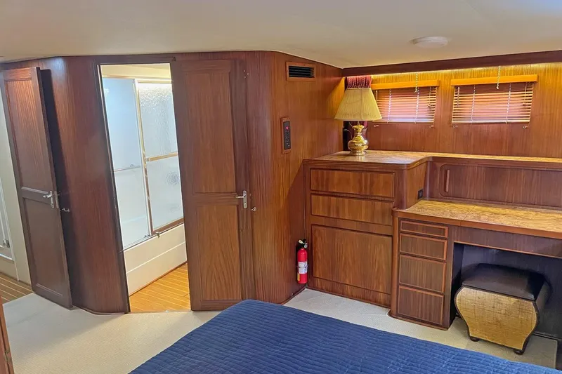 Long Tail Yacht Photos Pics Interior of 1985 Hatteras 58 Motor Yacht with wood paneling and built-in furniture.
