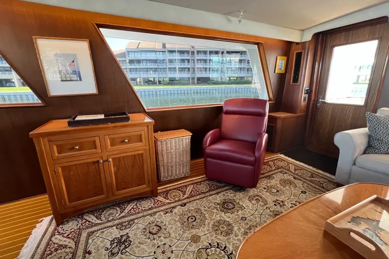 Long Tail Yacht Photos Pics Interior of 1985 Hatteras 58 Motor Yacht with elegant wood paneling and plush seating.
