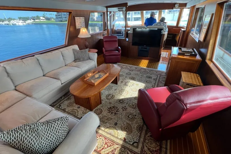 Long Tail Yacht Photos Pics Luxurious interior of 1985 Hatteras 58 Motor Yacht with elegant seating and panoramic windows.