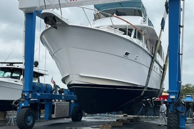 Long Tail Yacht Photos Pics 1985 Hatteras 58 Motor Yacht in dry dock, supported by a blue boat lift.