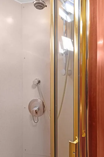 Simbra Yacht Photos Pics Luxurious shower in 2006 Norseman 480S yacht with gold accents and modern fixtures.
