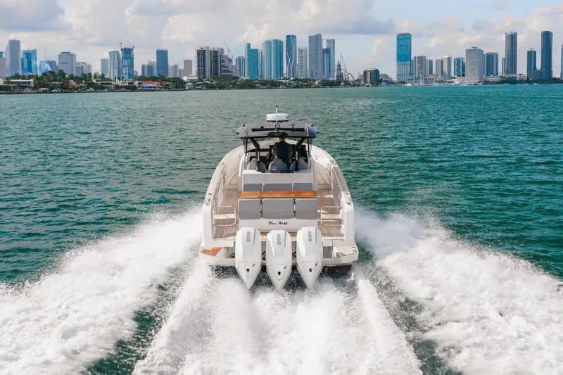 The Wolf Yacht Photos Pics 2021 Pardo Yachts 38 cruising with city skyline in background.