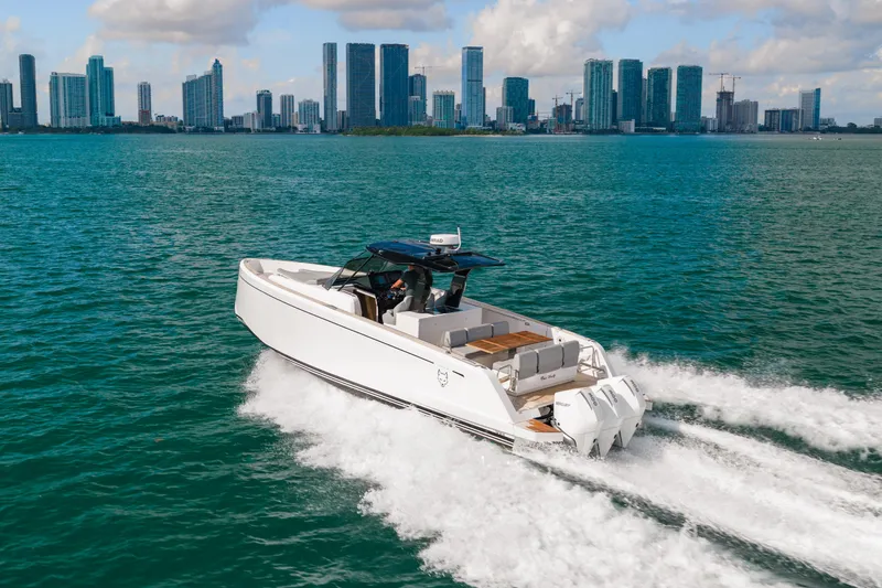 The Wolf Yacht Photos Pics 2021 Pardo Yachts 38 cruising on water with city skyline in background.