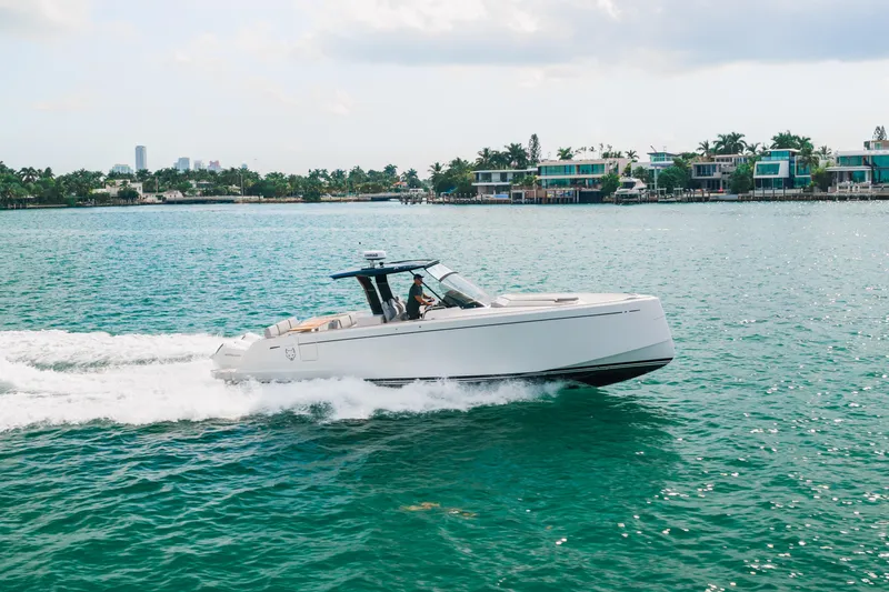 The Wolf Yacht Photos Pics 2021 Pardo Yachts 38 cruising on turquoise water near luxury waterfront homes.