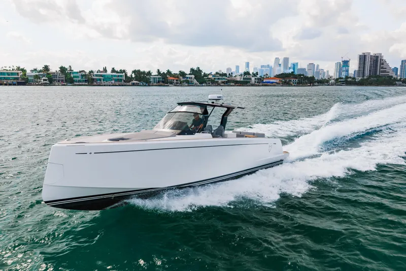 The Wolf Yacht Photos Pics 2021 Pardo Yachts 38 cruising on water with city skyline in background.