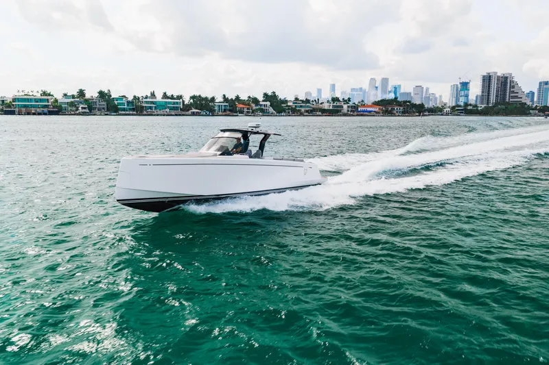 The Wolf Yacht Photos Pics 2021 Pardo Yachts 38 cruising on water with city skyline in background.
