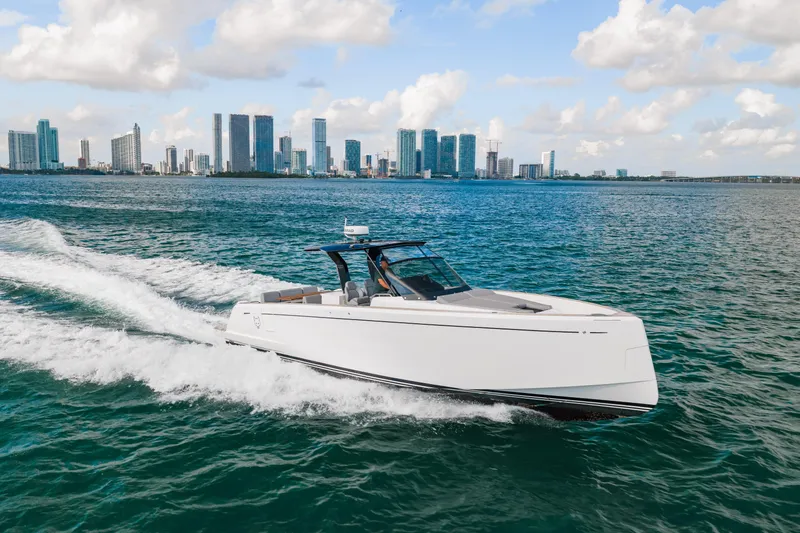 The Wolf Yacht Photos Pics 2021 Pardo Yachts 38 cruising on water with city skyline in background.
