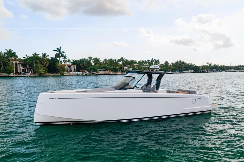 The Wolf Yacht Photos Pics 2021 Pardo Yachts 38 cruising on a scenic waterfront with palm trees.