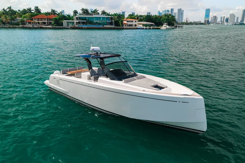 The Wolf Yacht Photos Pics 2021 Pardo Yachts 38 cruising on clear blue water near a city skyline.