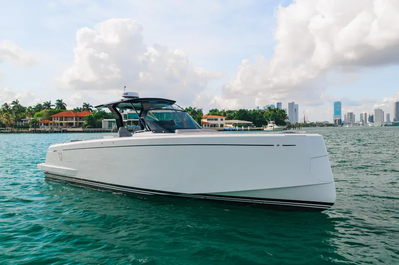 The Wolf Yacht Photos Pics 2021 Pardo Yachts 38 cruising on a scenic waterfront with city skyline.