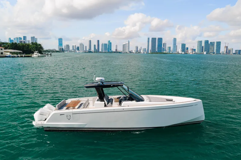 The Wolf Yacht Photos Pics 2021 Pardo Yachts 38 cruising on water with city skyline in background.