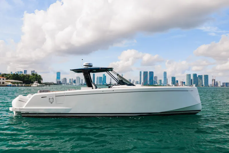 The Wolf Yacht Photos Pics 2021 Pardo Yachts 38 cruising on water with city skyline in background.