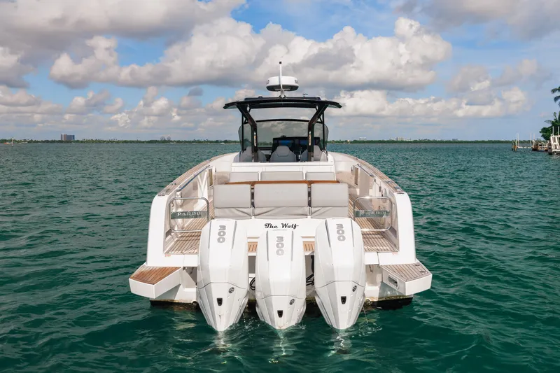 The Wolf Yacht Photos Pics 2021 Pardo Yachts 38 on water, rear view with triple engines, clear sky.