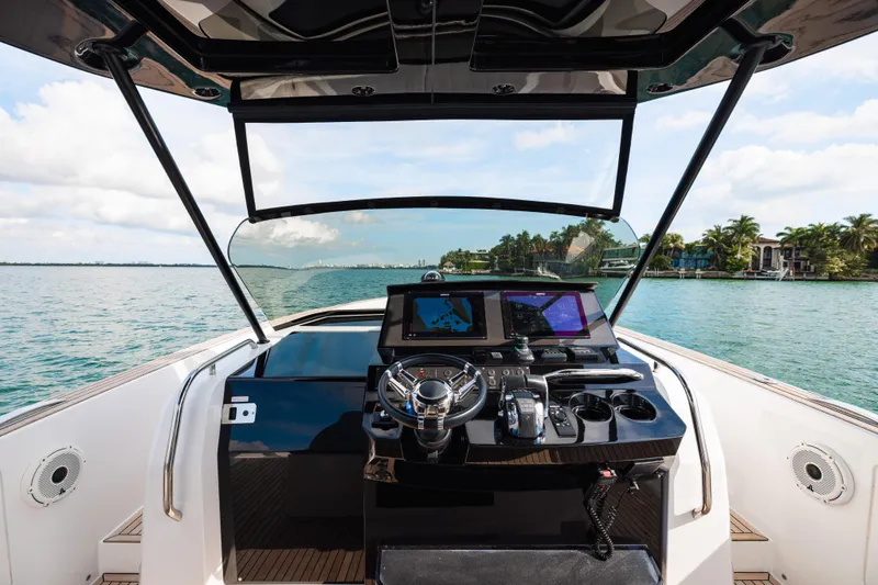 The Wolf Yacht Photos Pics Cockpit view of 2021 Pardo Yachts 38, featuring modern navigation equipment and scenic waterway.