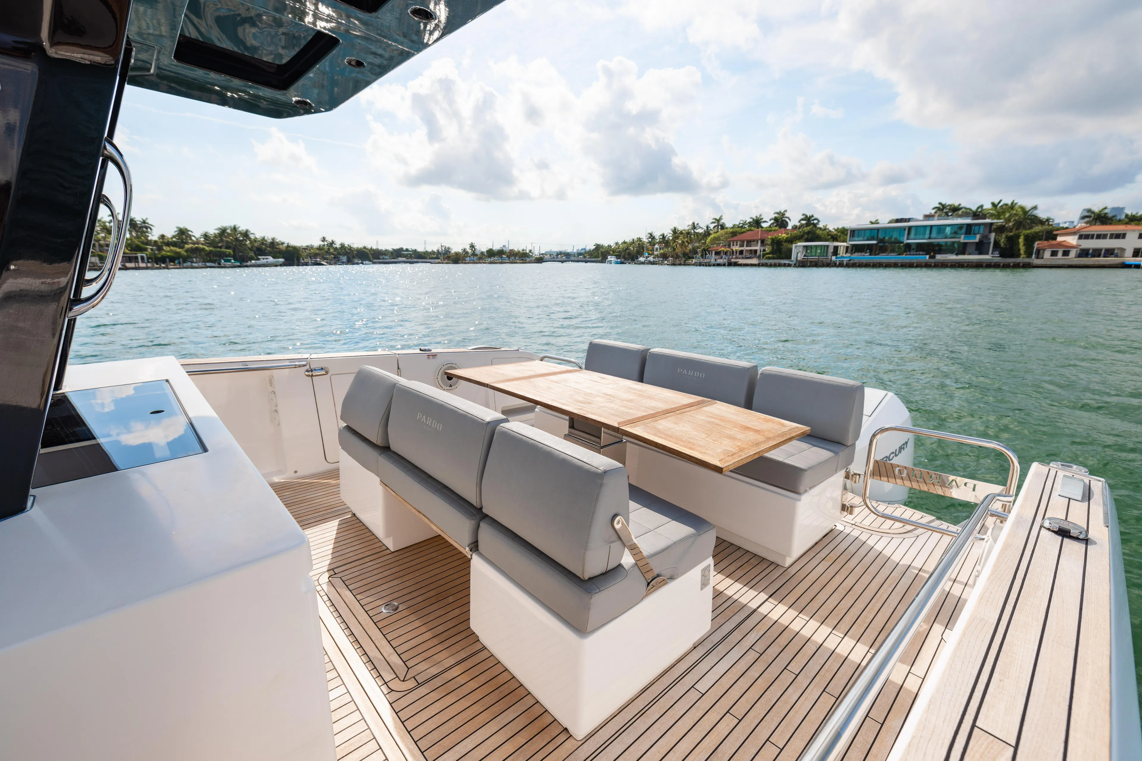 The Wolf Yacht Photos Pics Luxury 2021 Pardo Yachts 38 with elegant seating and scenic waterfront view.