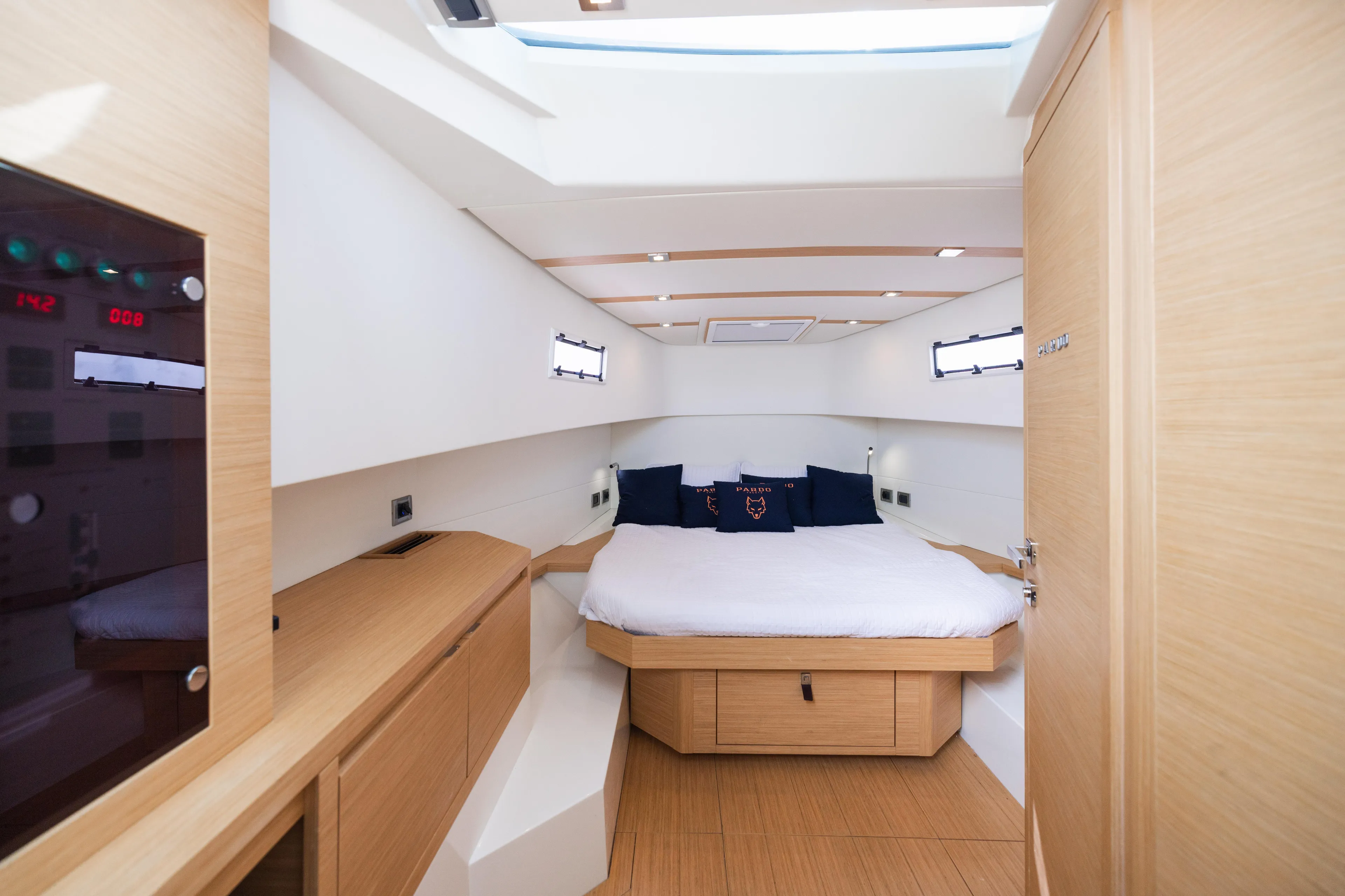 The Wolf Yacht Photos Pics Luxurious cabin interior of 2021 Pardo Yachts 38, featuring modern wood finishes and cozy bedding.