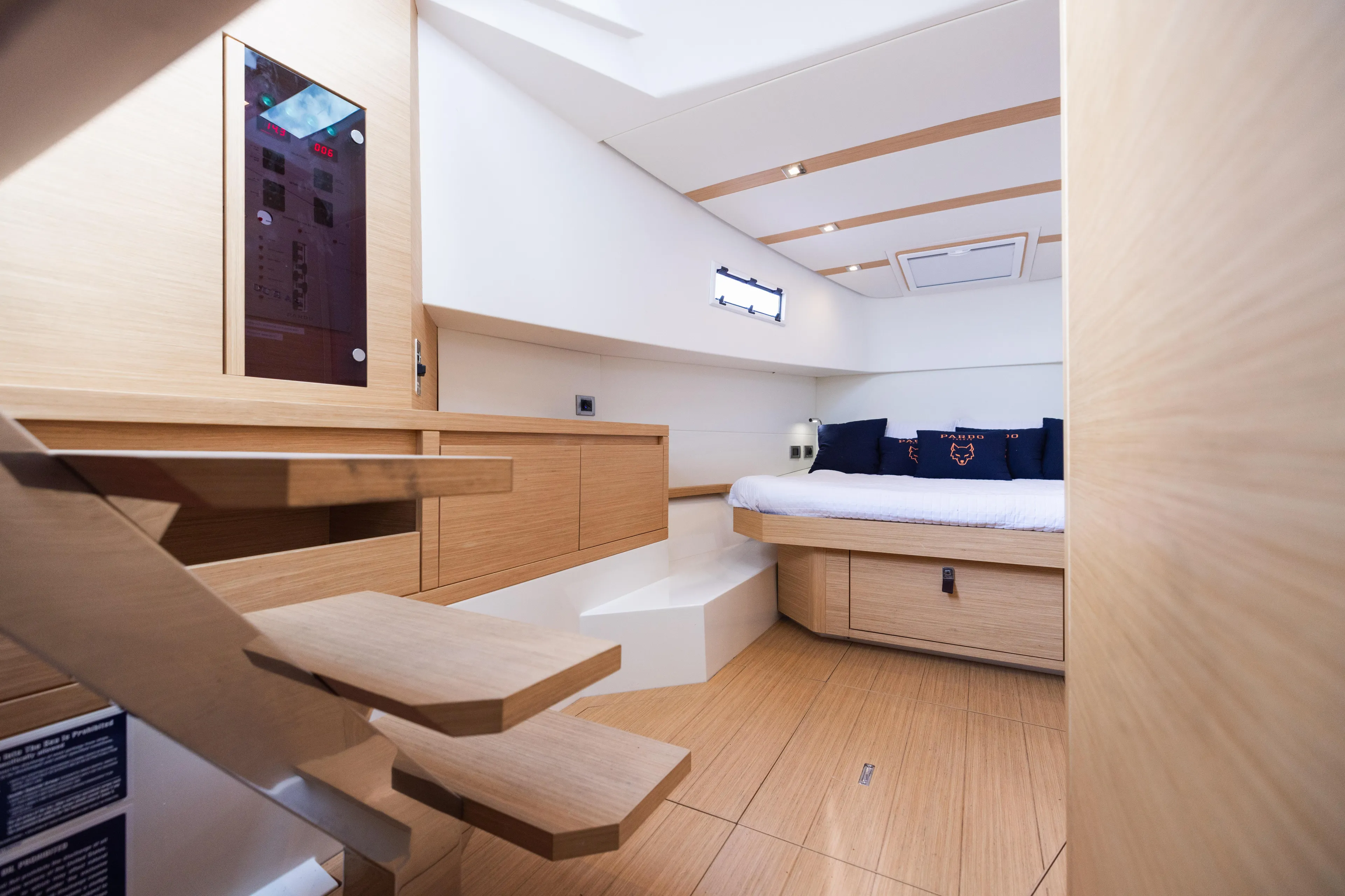 The Wolf Yacht Photos Pics Luxurious interior of 2021 Pardo Yachts 38, featuring modern wood finishes and cozy bedding.