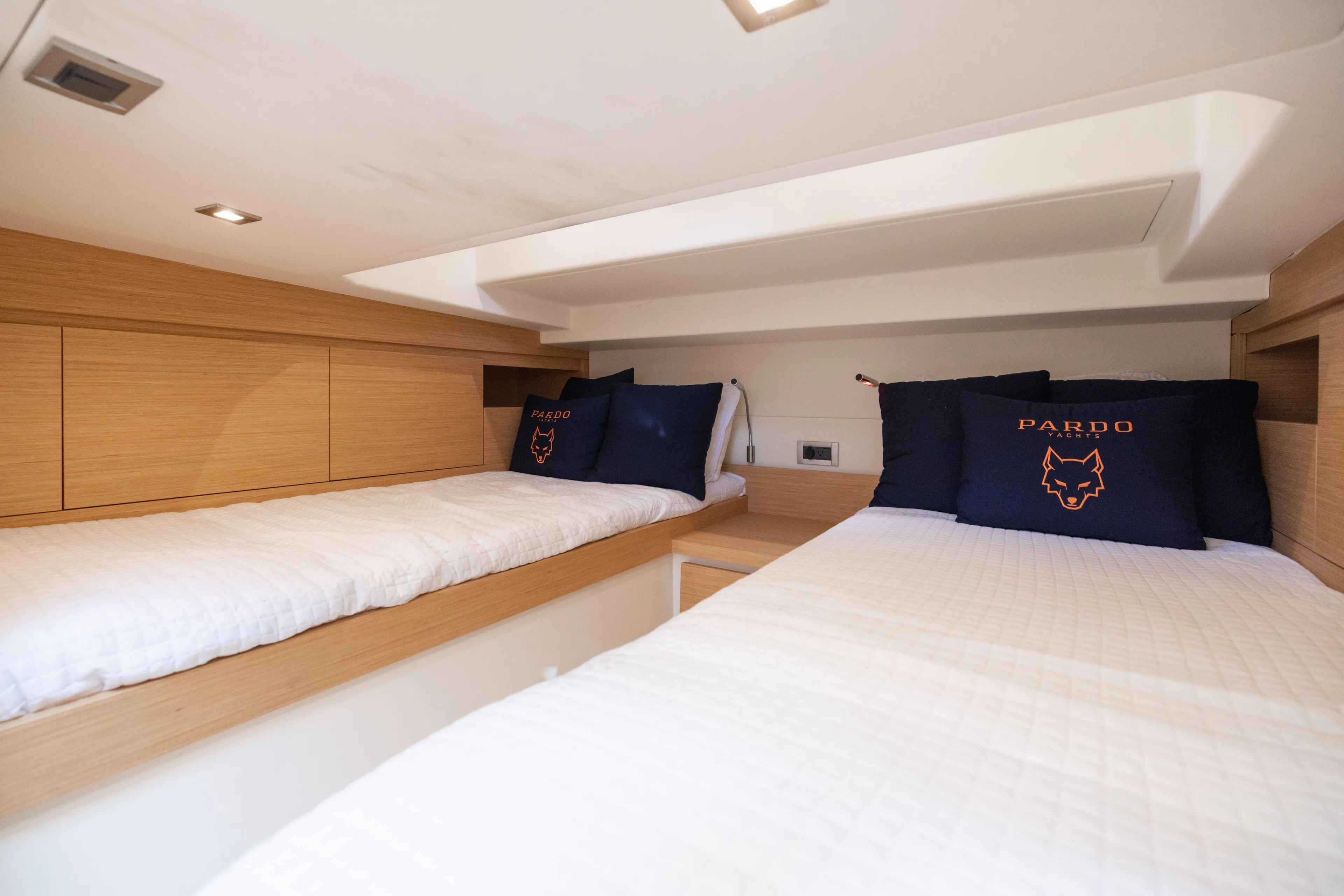 The Wolf Yacht Photos Pics Interior cabin of 2021 Pardo Yachts 38 with twin beds and branded pillows.