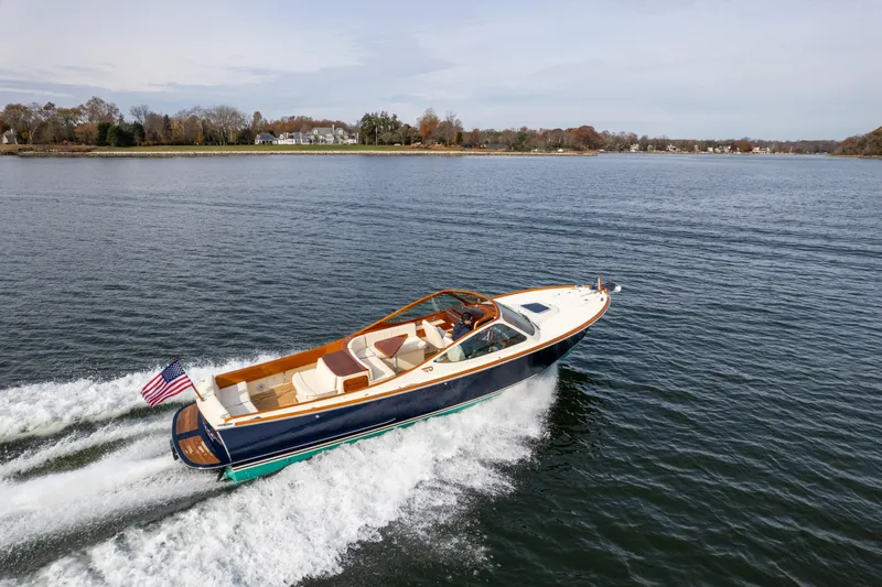 Ballymena Yacht Photos Pics 2006 Hinckley Talaria 29 R cruising on a serene lake with scenic shoreline.
