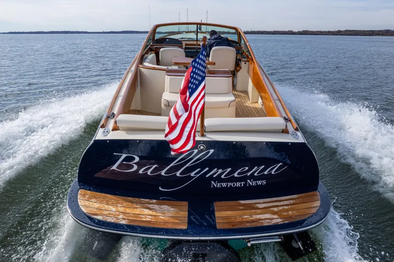 Ballymena Yacht Photos Pics 2006 Hinckley Talaria 29 R boat cruising with American flag on water.