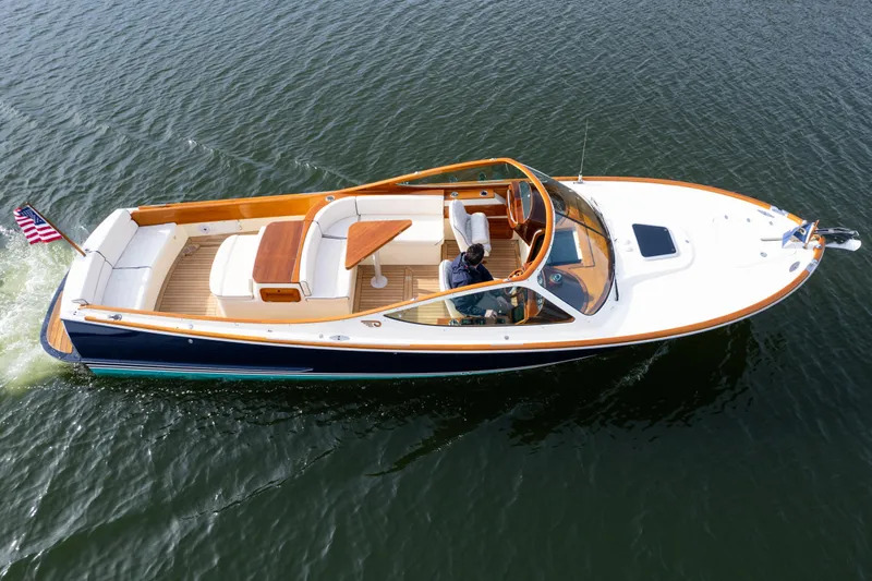 Ballymena Yacht Photos Pics 2006 Hinckley Talaria 29 R boat cruising on open water, featuring elegant design and American flag.