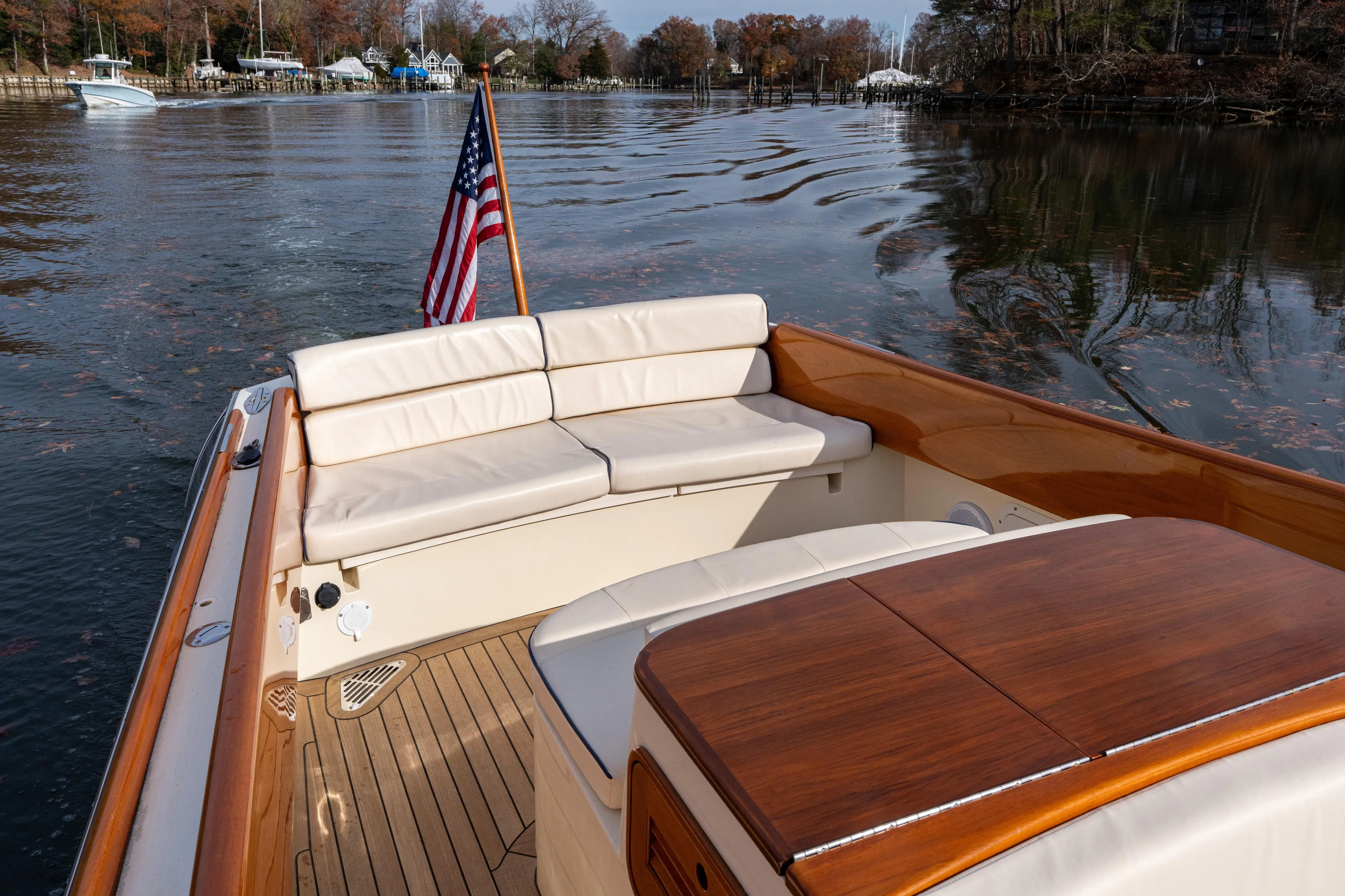 Ballymena Yacht Photos Pics 2006 Hinckley Talaria 29 R boat with American flag, elegant seating, and wooden deck.