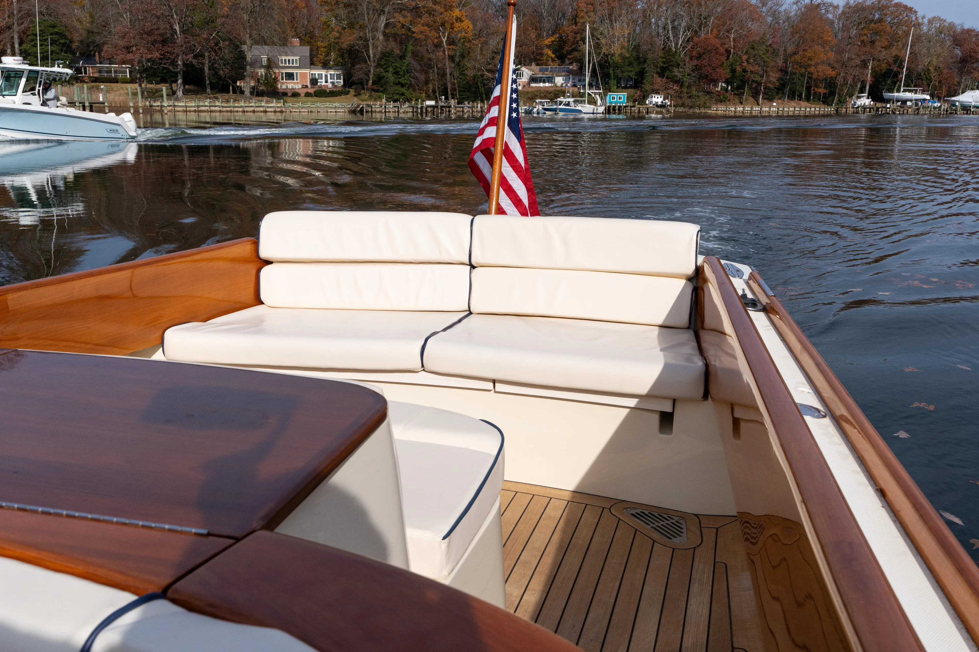 Ballymena Yacht Photos Pics 2006 Hinckley Talaria 29 R boat with elegant seating and American flag on calm water.