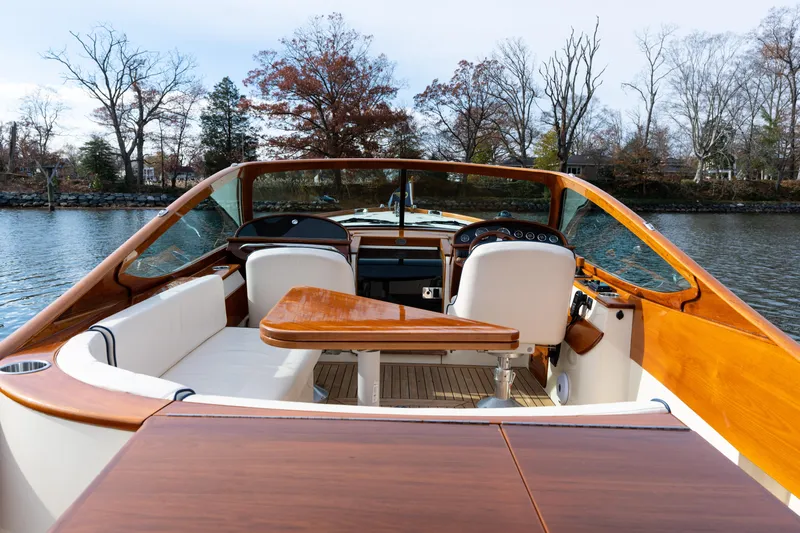 Ballymena Yacht Photos Pics 2006 Hinckley Talaria 29 R boat interior with wooden accents and white seating.