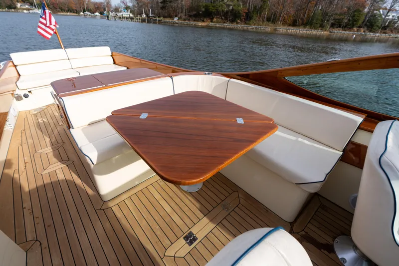 Ballymena Yacht Photos Pics Hinckley Talaria 29 R 2006 boat interior with wooden table and cushioned seating.