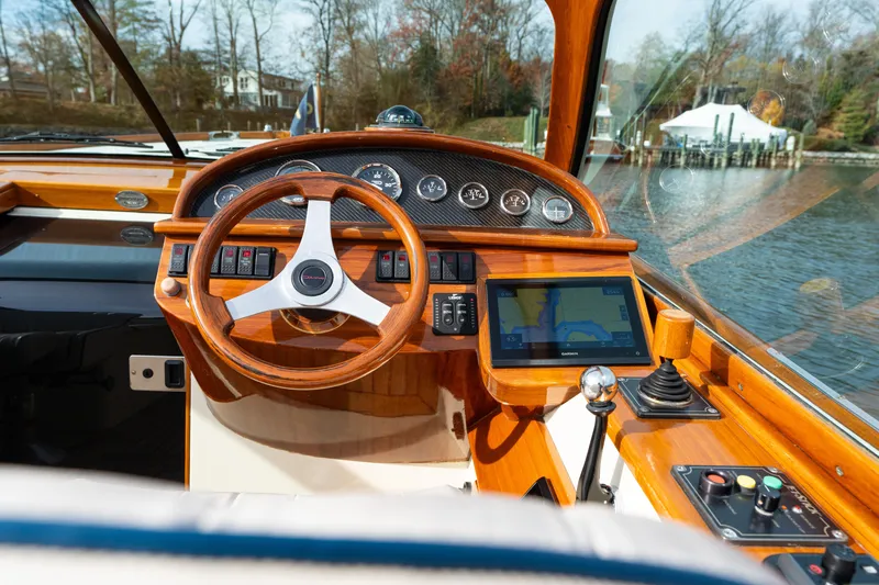 Ballymena Yacht Photos Pics 2006 Hinckley Talaria 29 R cockpit with wooden steering wheel and navigation display.