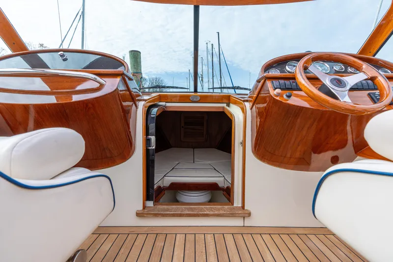 Ballymena Yacht Photos Pics Interior view of 2006 Hinckley Talaria 29 R yacht with wooden dashboard and seating.