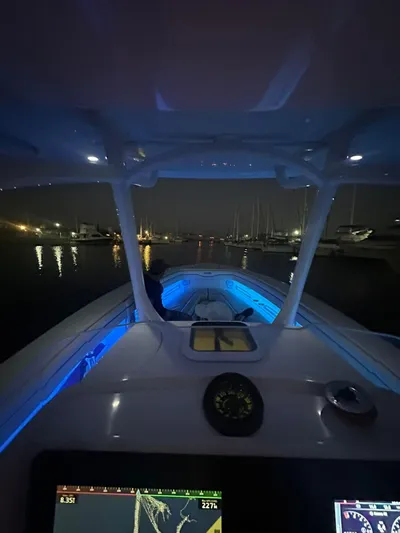  Yacht Photos Pics 2014 Jupiter 30 HSF boat with illuminated dashboard and blue interior lights at night.