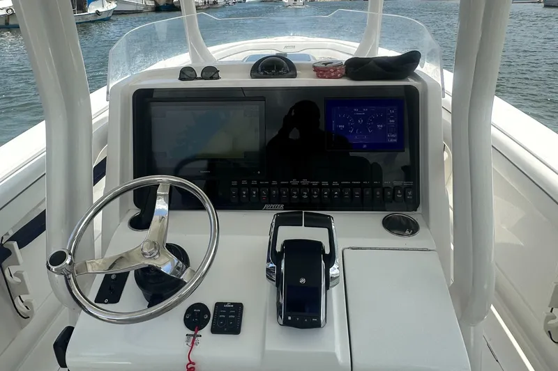  Yacht Photos Pics 2014 Jupiter 30 HSF boat dashboard with steering wheel and navigation controls.