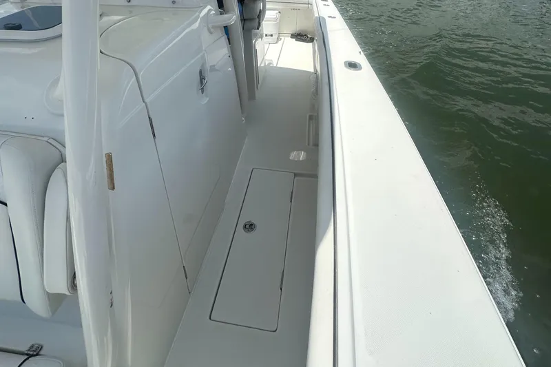  Yacht Photos Pics 2014 Jupiter 30 HSF boat deck with white seating and storage compartment.