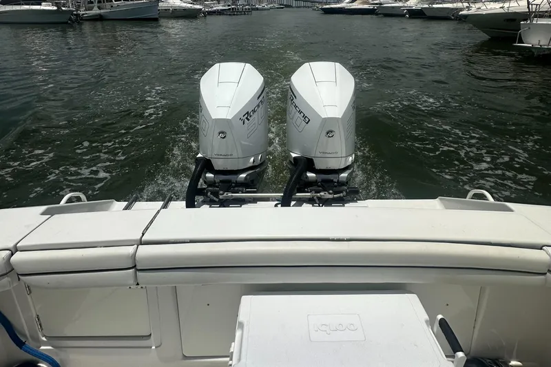  Yacht Photos Pics Twin outboard motors on a 2014 Jupiter 30 HSF boat in a marina setting.