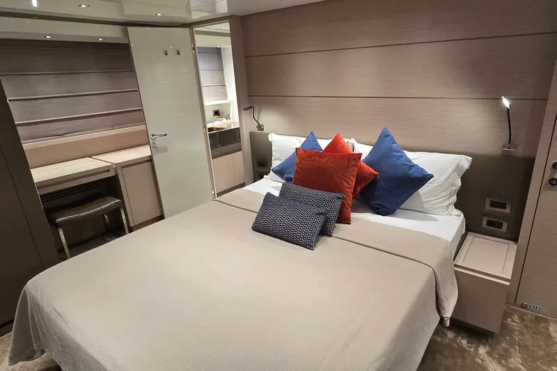  Yacht Photos Pics Luxurious bedroom interior of 2021 Sanlorenzo SL78 yacht with modern decor and colorful pillows.