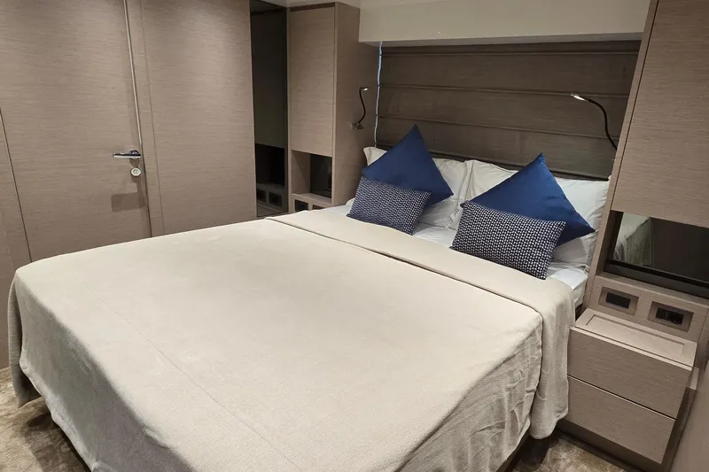  Yacht Photos Pics Luxurious bedroom interior of 2021 Sanlorenzo SL78 yacht with elegant bedding and blue pillows.