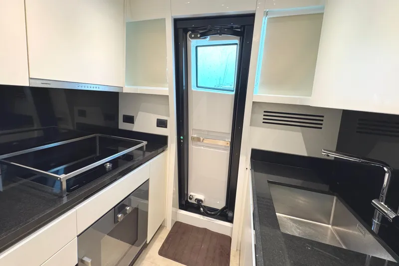  Yacht Photos Pics Modern kitchen in 2021 Sanlorenzo SL78 yacht with sleek countertops and appliances.