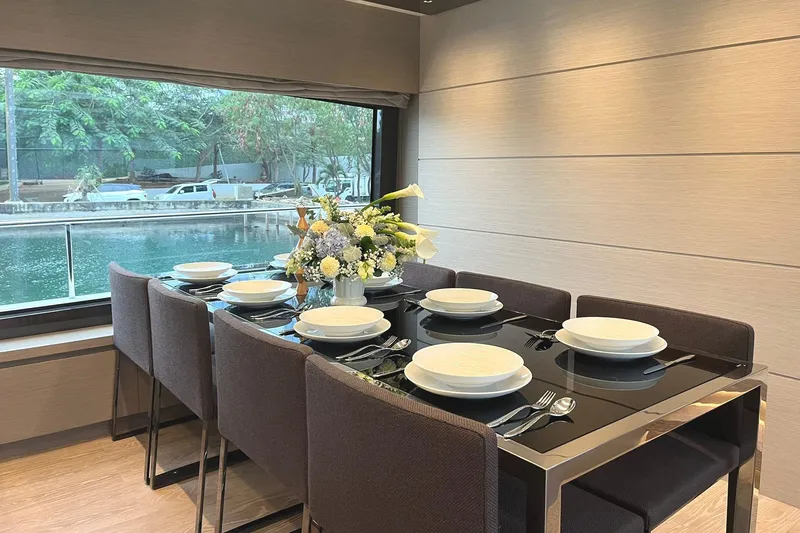  Yacht Photos Pics Elegant dining area on 2021 Sanlorenzo SL78 yacht with floral centerpiece and waterfront view.