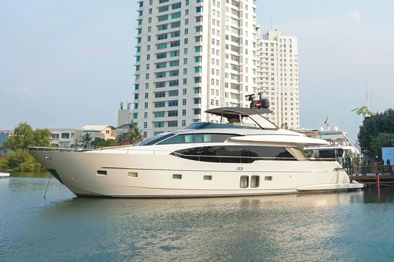  Yacht Photos Pics Luxury 2021 Sanlorenzo SL78 yacht docked near modern high-rise buildings.