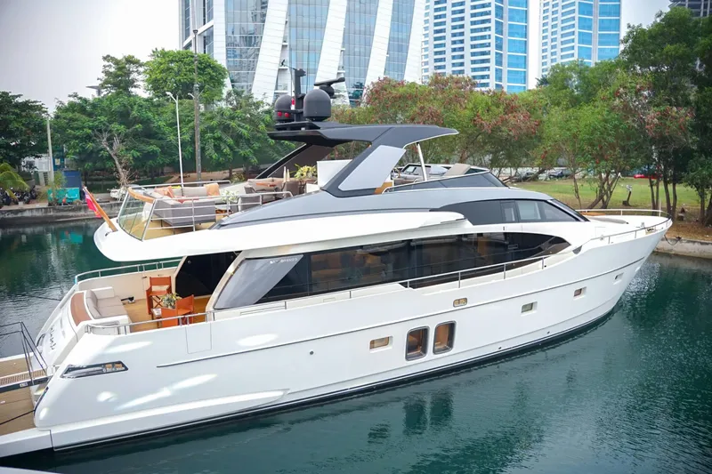  Yacht Photos Pics Sanlorenzo SL78 2021 luxury yacht docked near modern buildings and lush greenery.