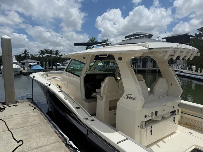  Yacht Photos Pics 2022 Scout 425 LXF boat docked at marina under cloudy sky.