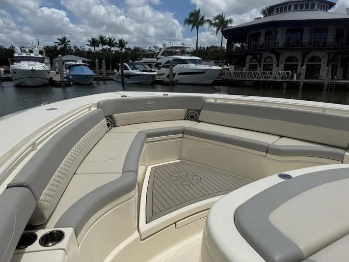  Yacht Photos Pics 2022 Scout 425 LXF boat interior with luxurious seating at a marina.